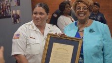 Deputy chief Lourdes Phelan, left, and mayor Jane Willaism-Warren, right, holding a proclamation recognizing  Phelan for breaking the department's glass ceiling.